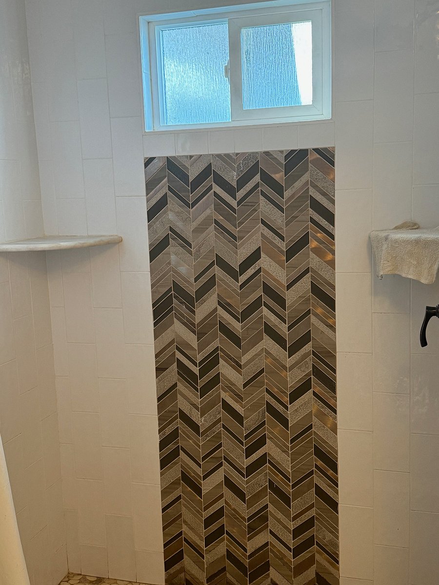 Large shower with high shower head for anyone who may be very tall 