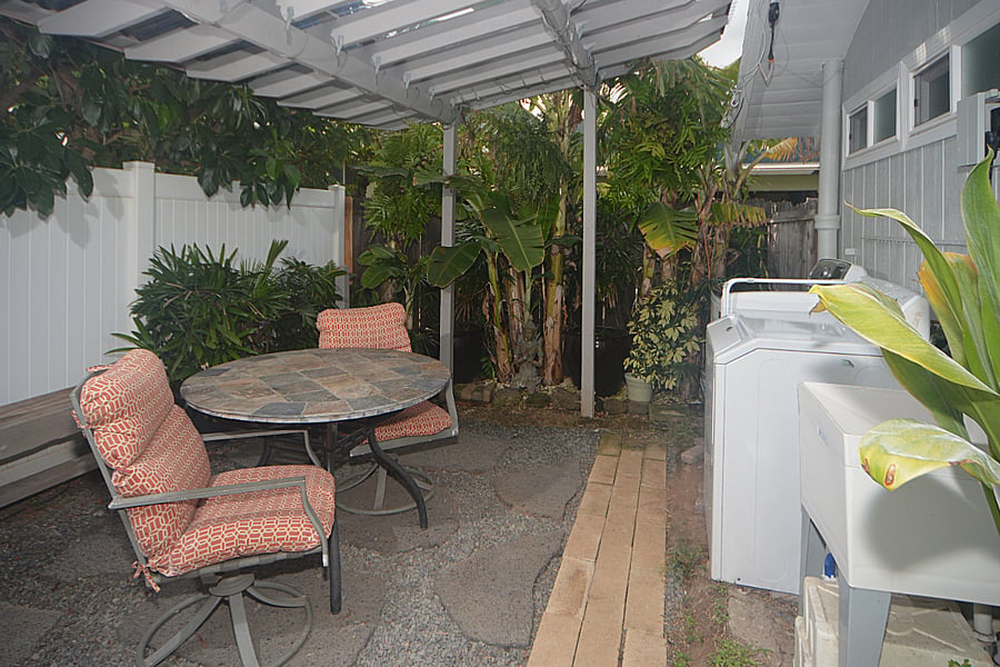 Pergola area with full sized washer/dryer and exterior sink