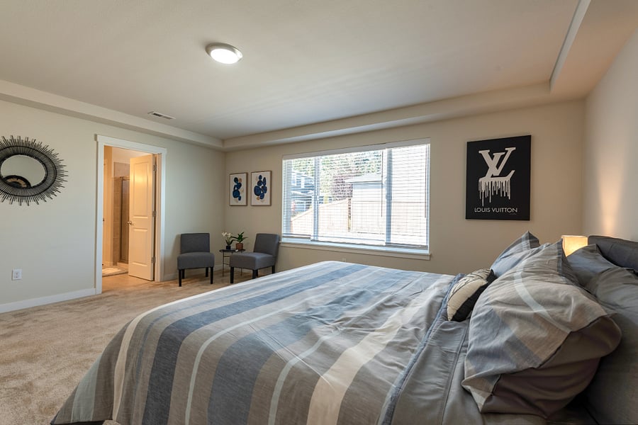 Another view of the Primary Bedroom. Private bath with walk in shower double vanity sinks