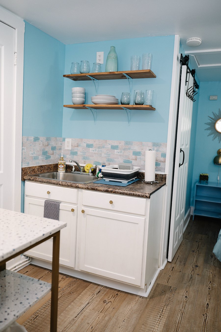 Kitchenette with dihes, glasses, cookware and essentials