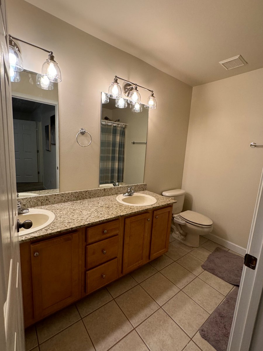 Master bathroom with double vanity with medicine cabinet, & shower/tub combo