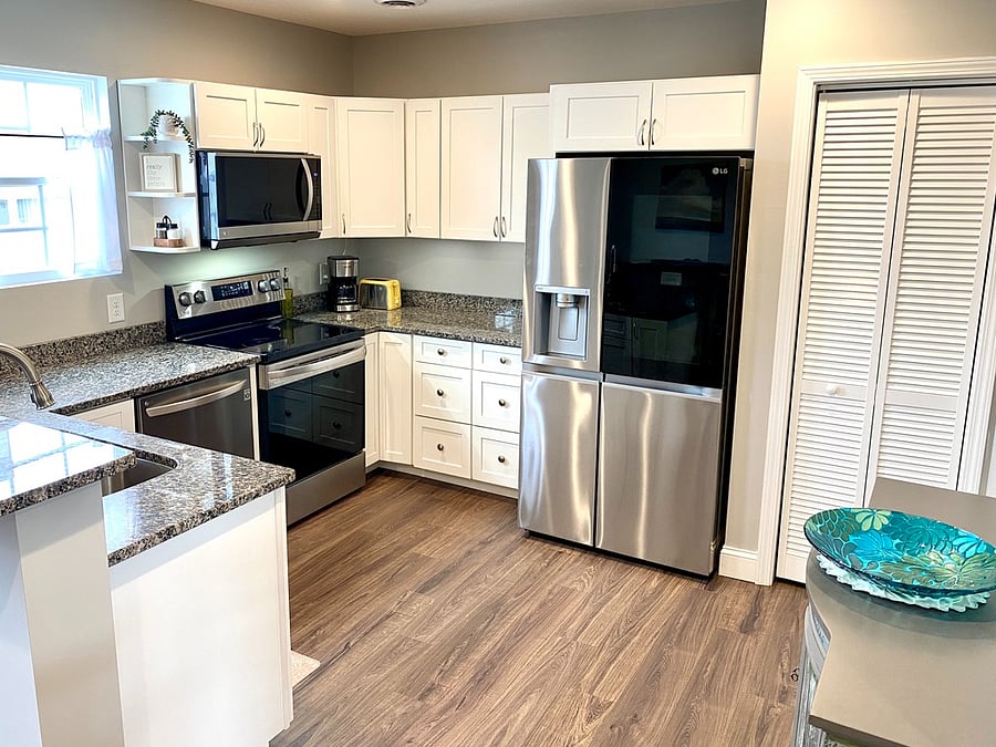 Kitchen has full-size appliances, craft ice maker, and garbage grinder. Fully equipped with dishes, cookware, and food storage containers. Starter items including fridge condiments, salt/pepper, olive oil.