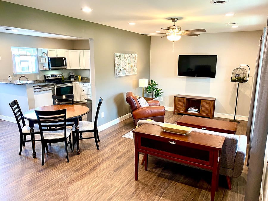 Open concept living room to dining room to kitchen area.