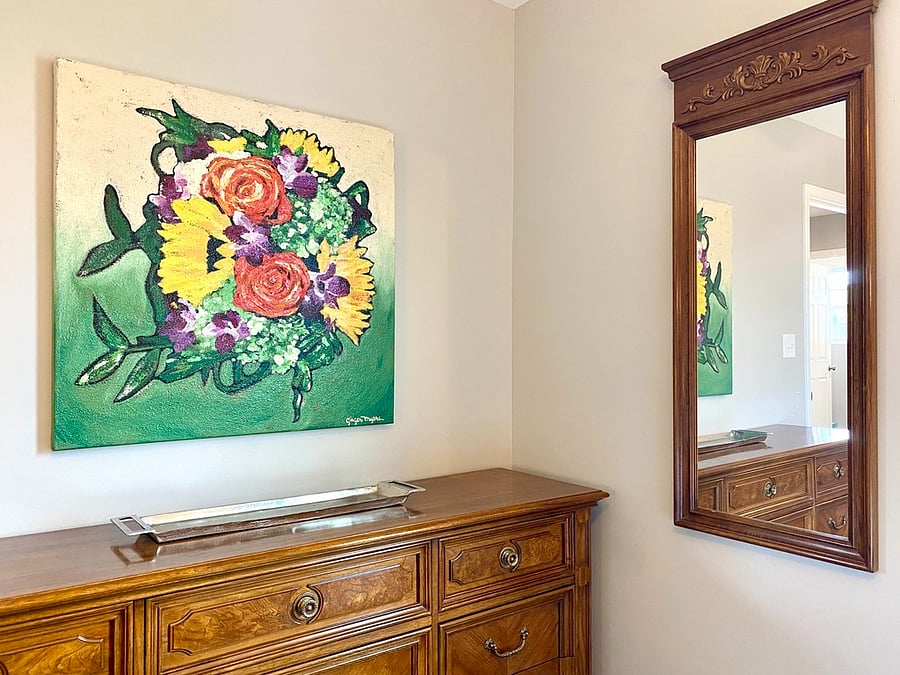 Twin bedroom with full-length mirror and original artwork.