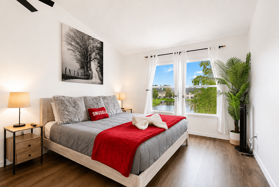 Primary bedroom with king bed, lake view and generous space for an extended stay.