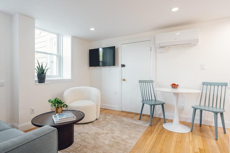 Living and Dining with great sunlight and Tv Mounted to wall