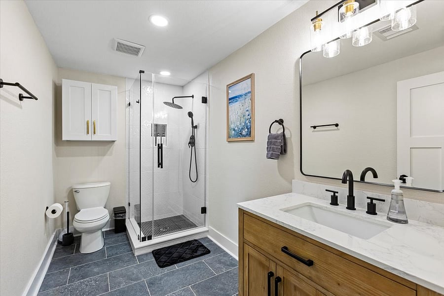 Downstairs primary bathroom with glass shower