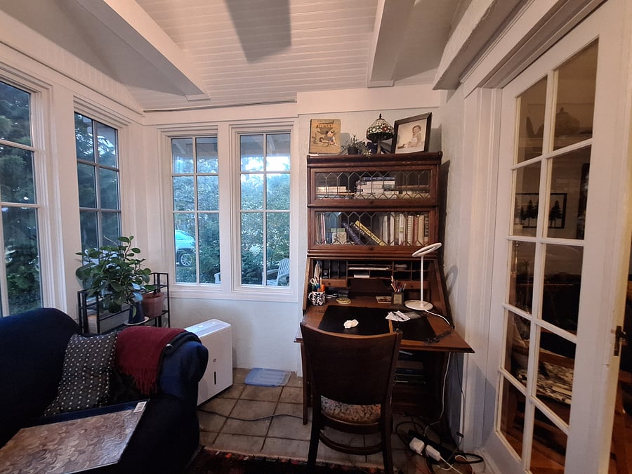 My favorite room, the "sunroom or Florida room" with couch, desk and lots of windows.