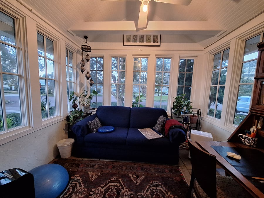 My favorite room, the "sunroom or Florida room" with couch, desk and lots of windows.