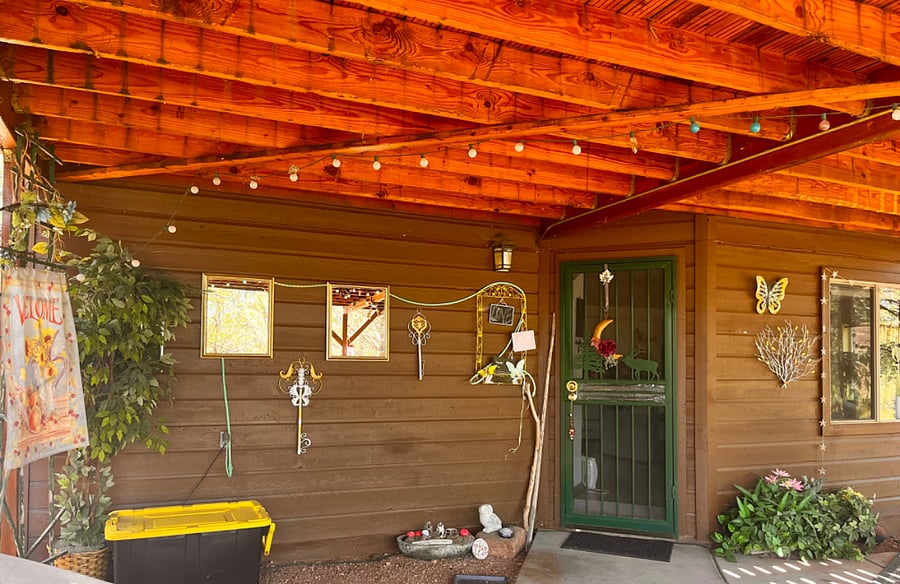 Private entry and deck. White lights for cozy evening relaxation. Yellow tub contains camping gear in case you want to spend a night or two in the wilds.