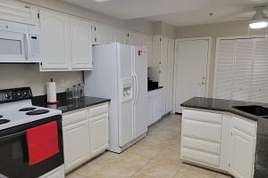 KItchen, showing door to the garage.  Behind the bifold doors are the washer and dryer