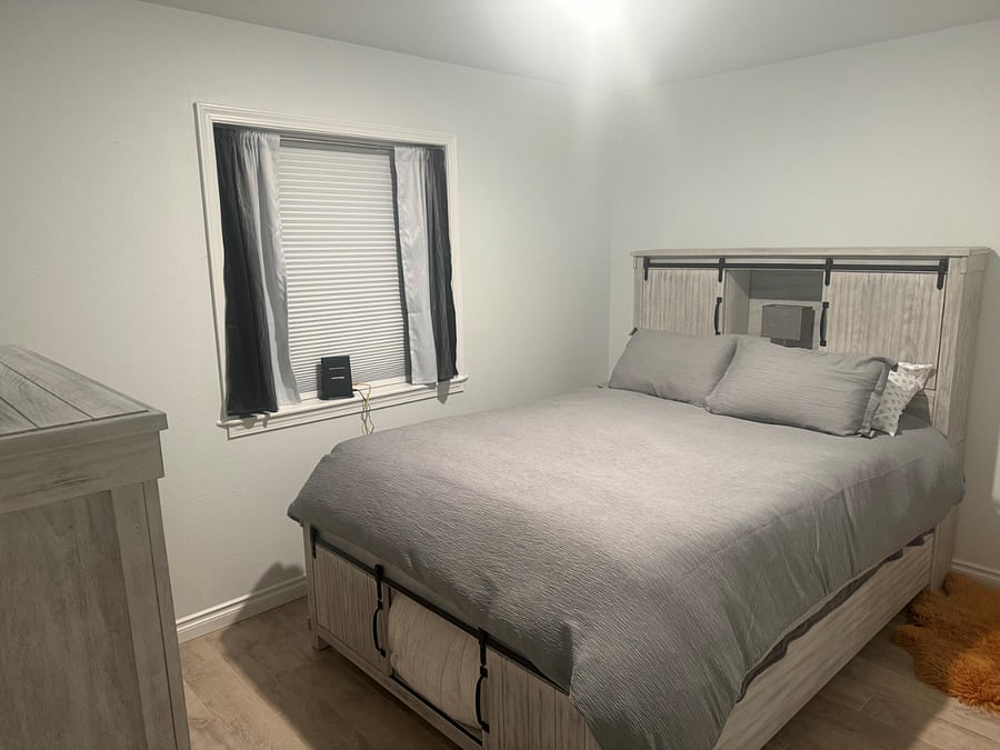 Queen Bed with Dresser, chair and smart TV