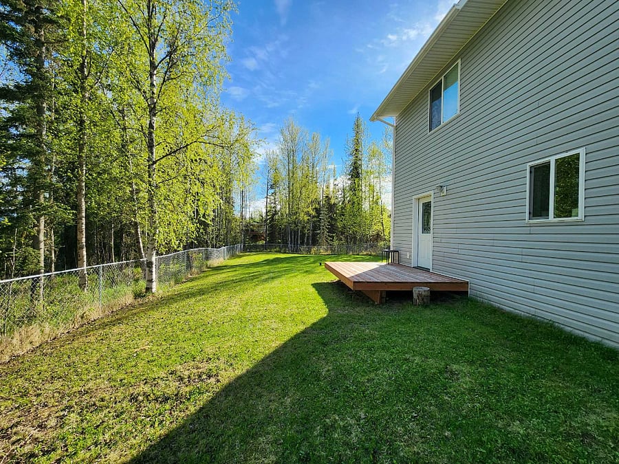 Large backyard with deck, Traeger grill, fire pit and completely fenced 
