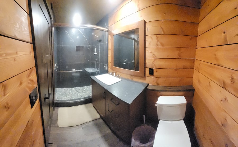 Full bath, granite shower with glass sliding door, vanity storage & timed exhaust fan.