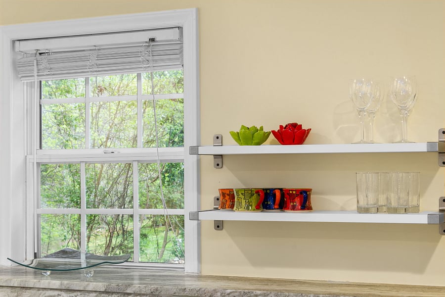 Window above kitchen sink with shelves