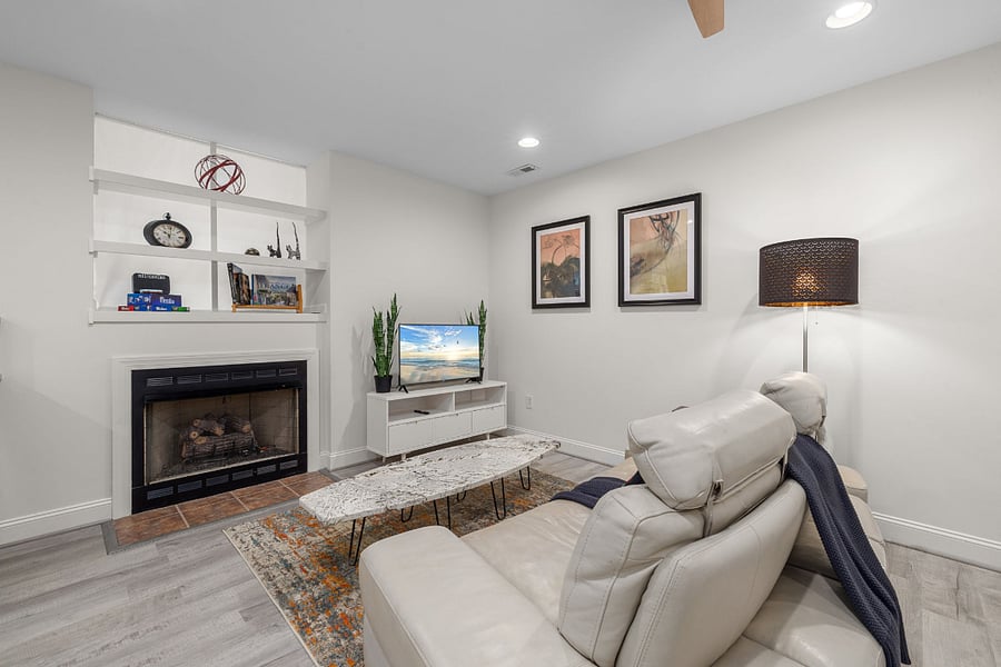 Living area with cozy gas fireplace and TV