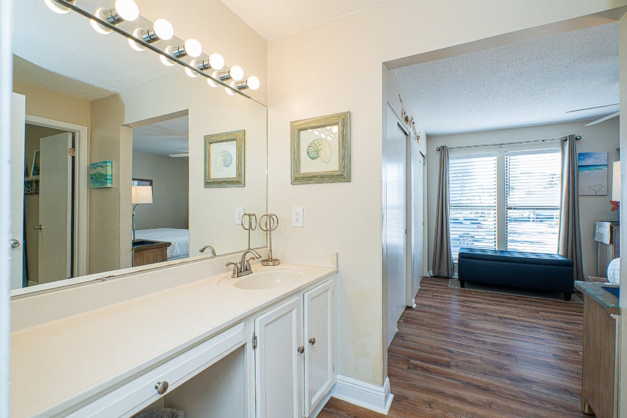 Bedroom 1 with King bed, TV, vanity area, and en-suite