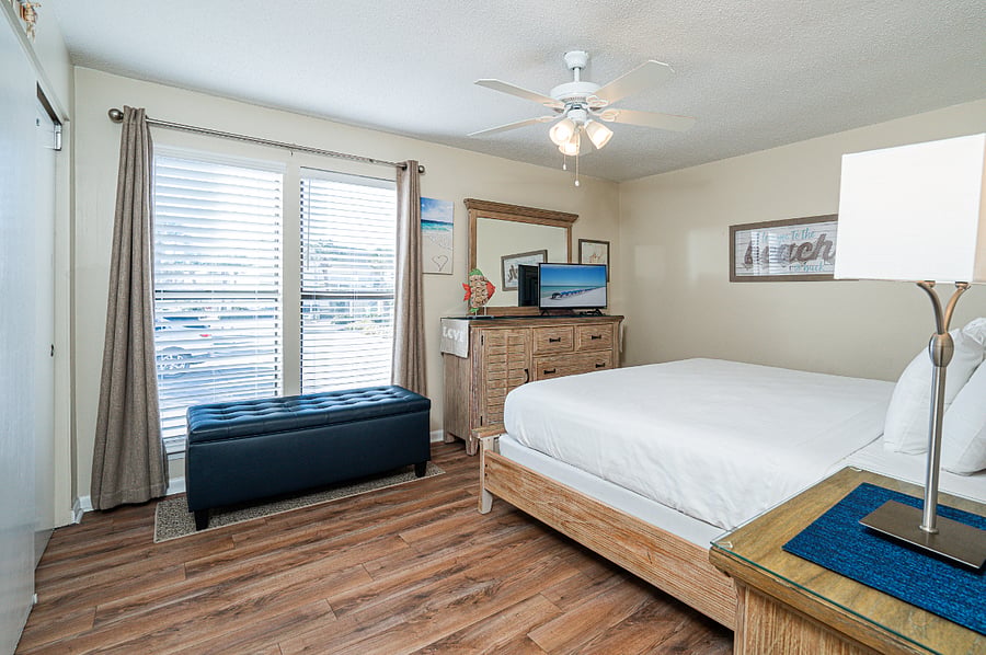 Bedroom 1 with King bed, TV, vanity area, and en-suite