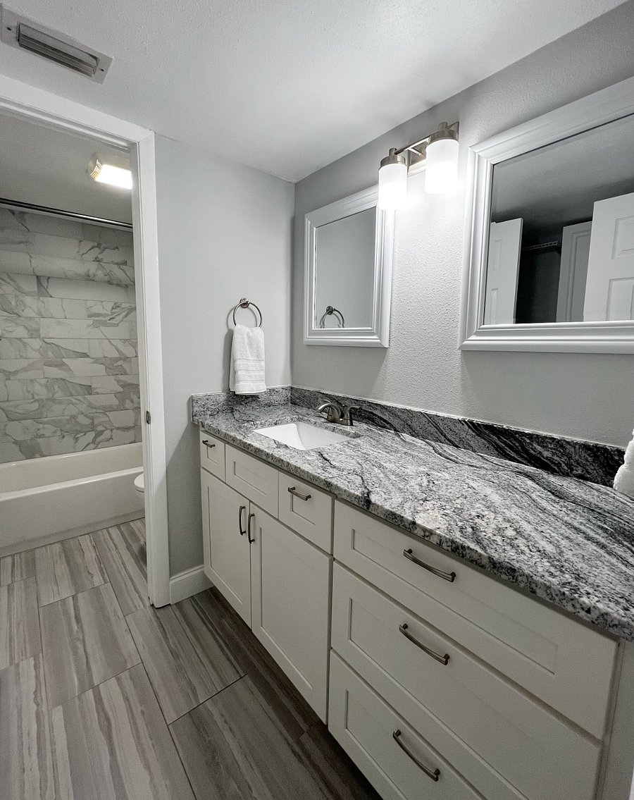 Full bathroom with plenty of counter space and a tub/shower combo