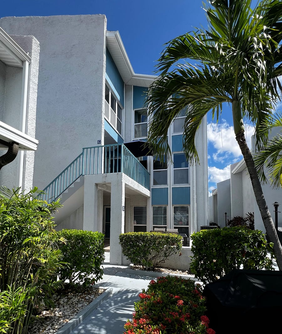 Side view of the condo building. There is one flight of exterior stairs to reach this unit.