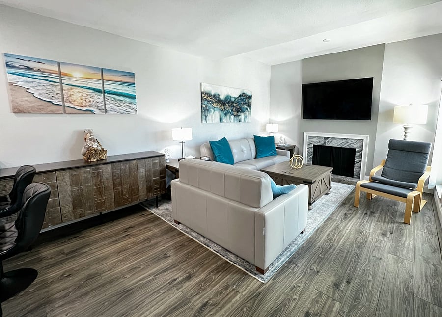 Front entrance into the living room with access to the kitchen and dining spaces too.