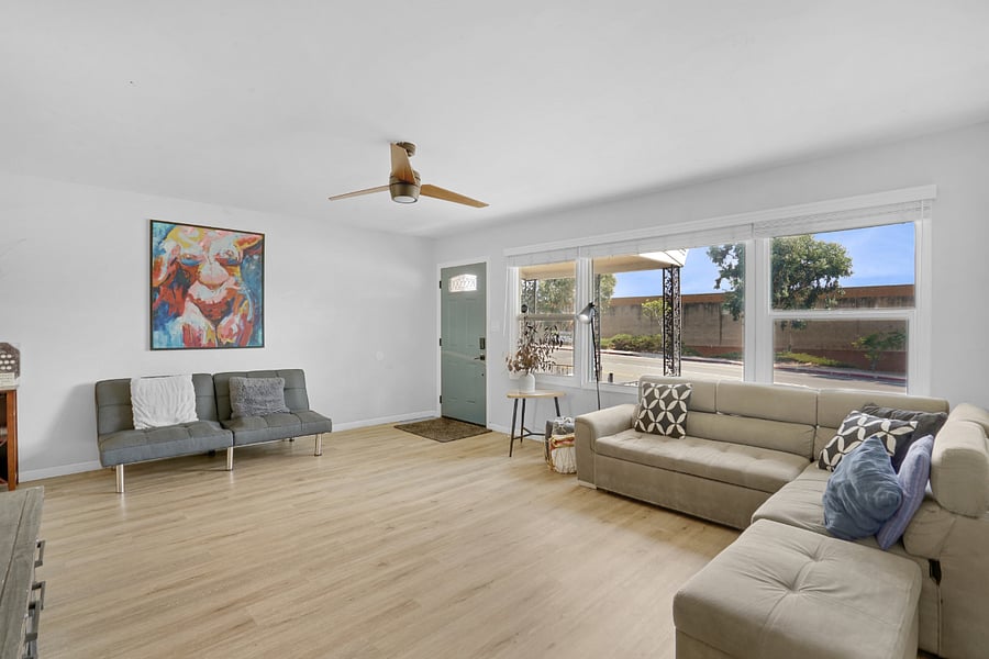 Spacious Living Room with two couches, Flat Screen TV, and lots of Natural Sunlight