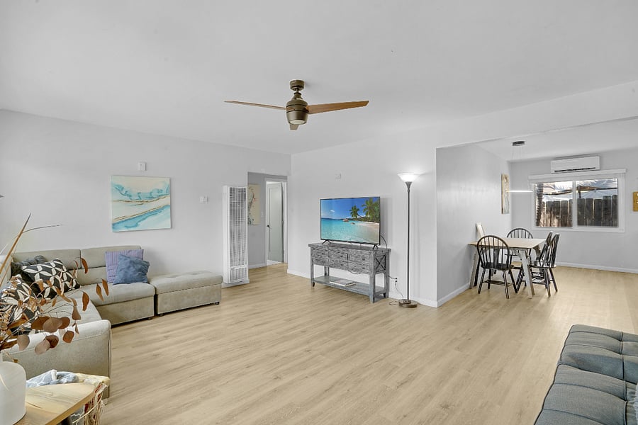Spacious Living Room with two couches, Flat Screen TV, and Dinning Area