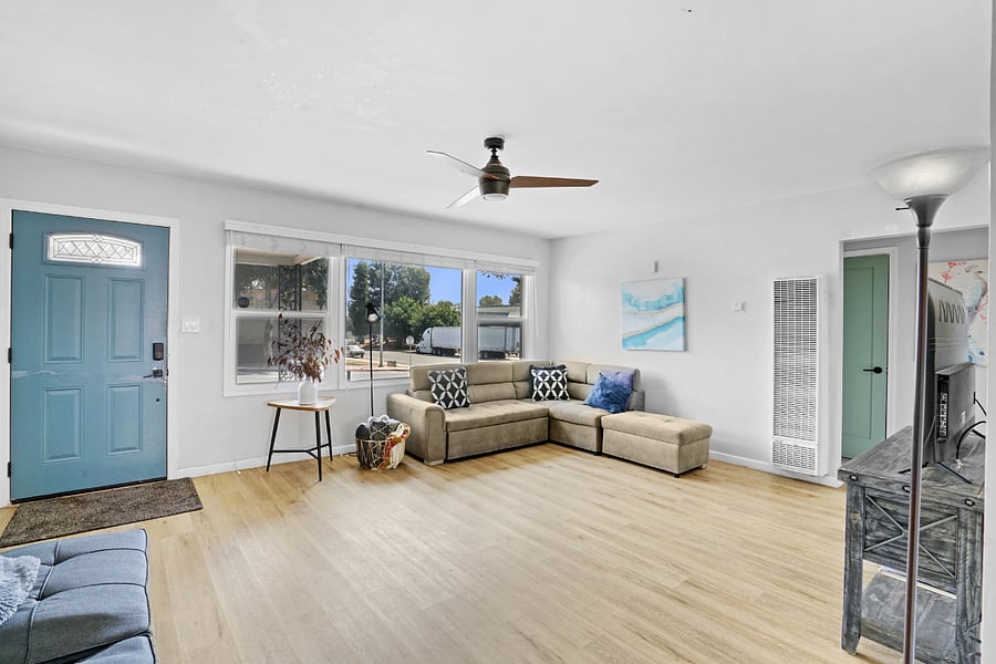 Spacious Living Room with two couches, Flat Screen TV, and lots of Natural Sunlight