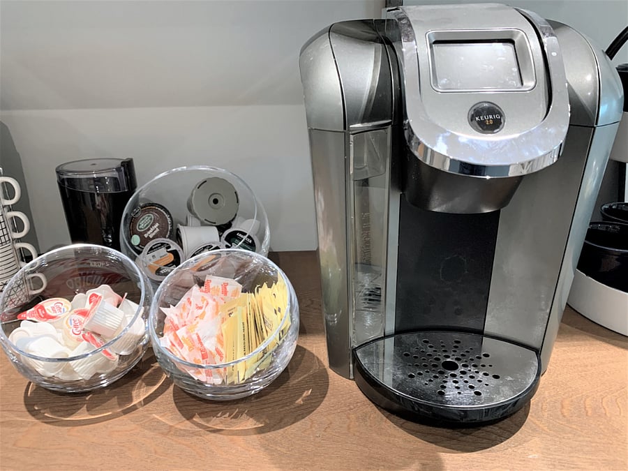 Keurig single-use and carafe coffee maker with K-cups, sugars, and creamers provided