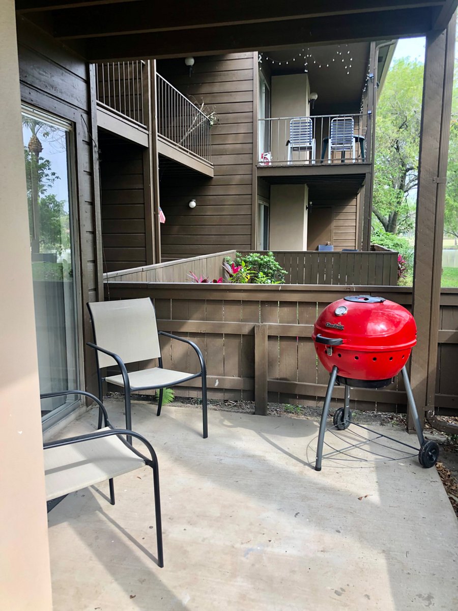 Outdoor grill in covered patio and seating available