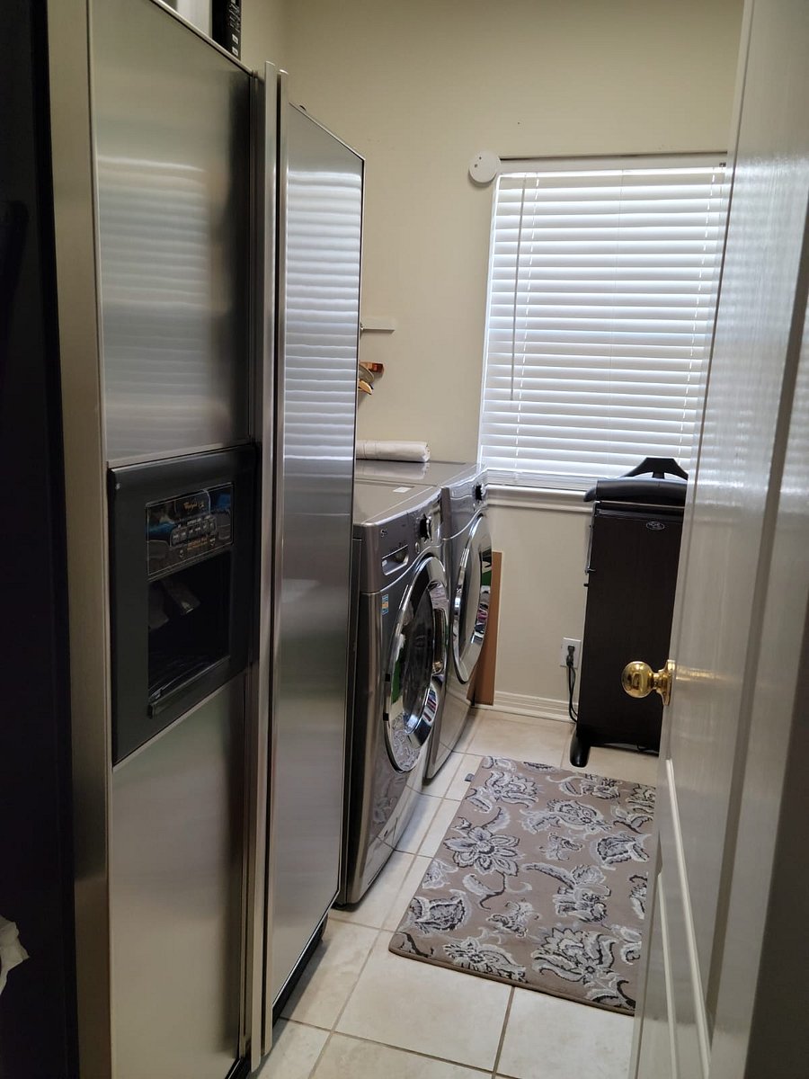 There is an extra fridge in the laundry area for convenience and storage shelving.