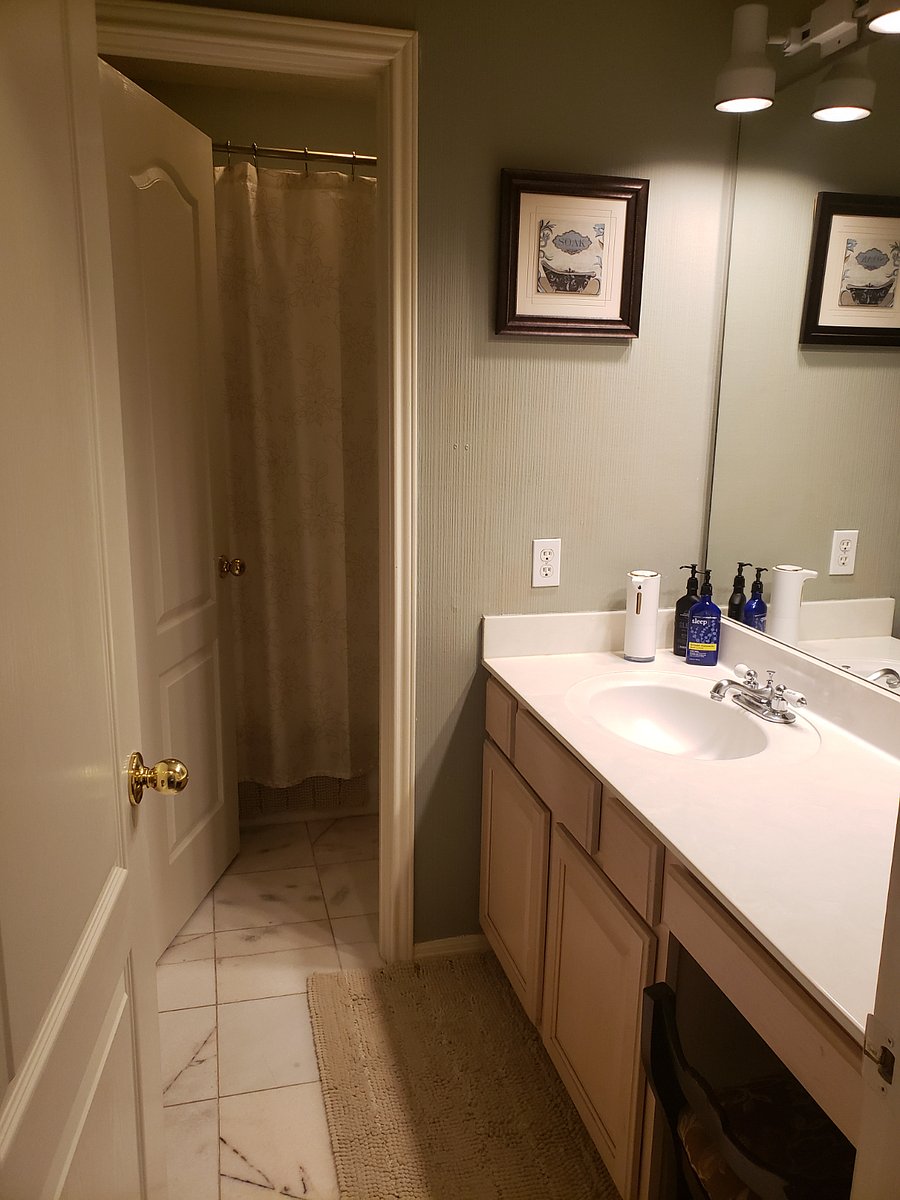 Second bathroom with tub and shower is located between two bedroom 2 and 3.