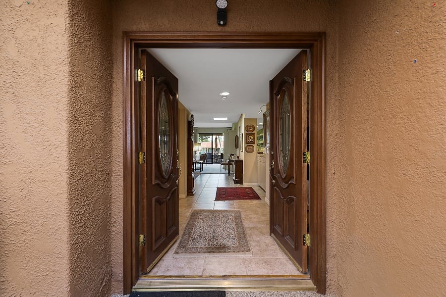 Custom front doors to foyer and view through to rear patio.