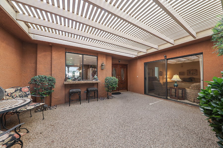 Trellised front patio & front door & master bedroom patio doors & breakfast bar.