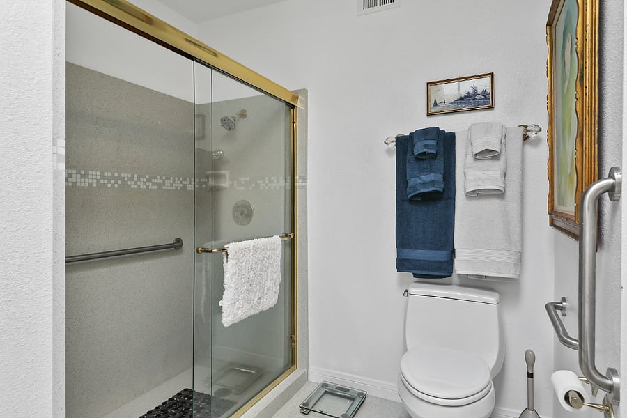 Spacious & bright main bath w/ oversized custom quartz shower w/ glass doors.x