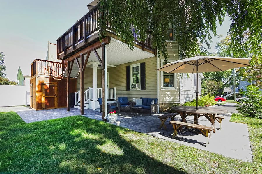 Shared outdoor patio area with picnic table and lounge seating area