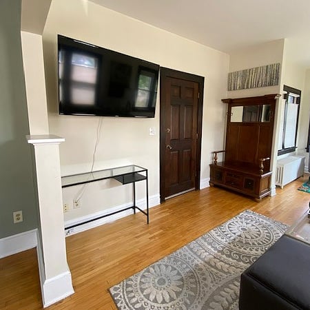 Our living room has access to the front, east side entrance of the house, and a huge 55" tv for after work zoning out. It comes with a fire stick and all the apps loaded in ready for your log-in.
