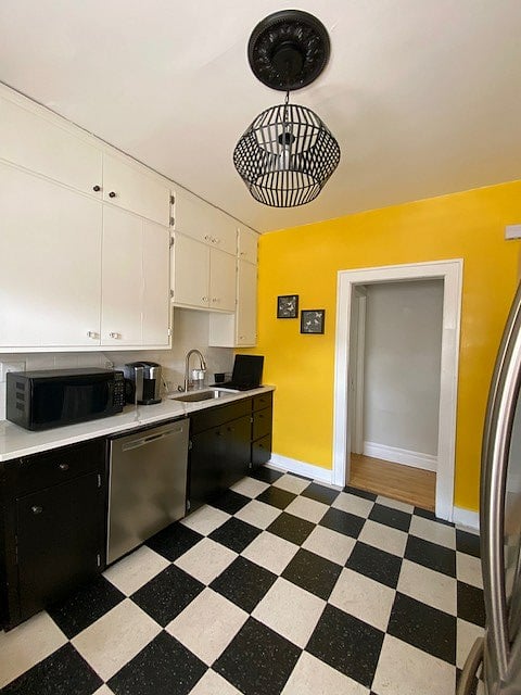 The kitchen is bright and sunny, with all the necessary appliances, cabinetry, fridge, range, and counter space. You can access the back hallway, bathroom, and both bedrooms from the kitchen as well as the dining room.