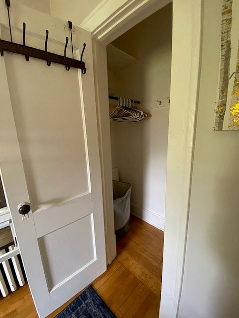 This closet extends to the left and right, with a laundry hamper and plenty of hangers for your clothes.