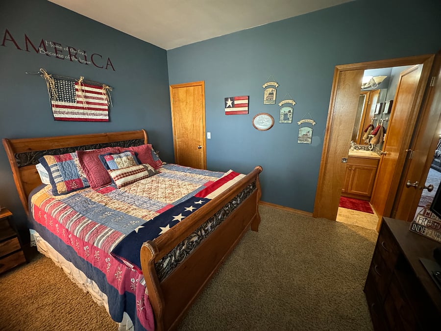 Bedroom #2 (Blue) Queen sized bed, showing entrance to bathroom #2