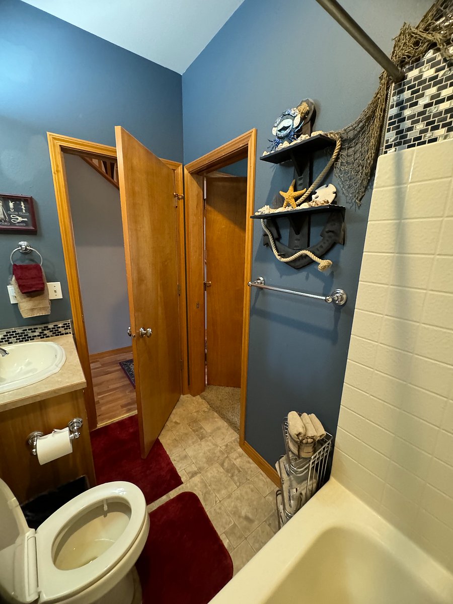 Bathroom #2 off of Bedroom #2 (Blue) showing hallway door and bedroom door