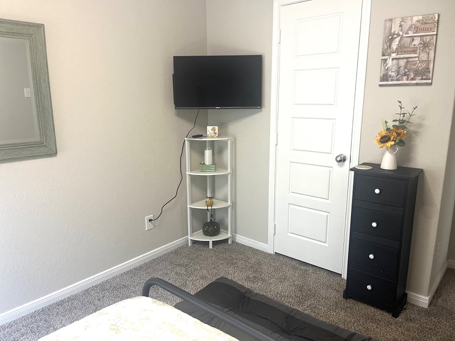 Roku tv, empty closet with hangers. small cloth drawers for socks and underwear.