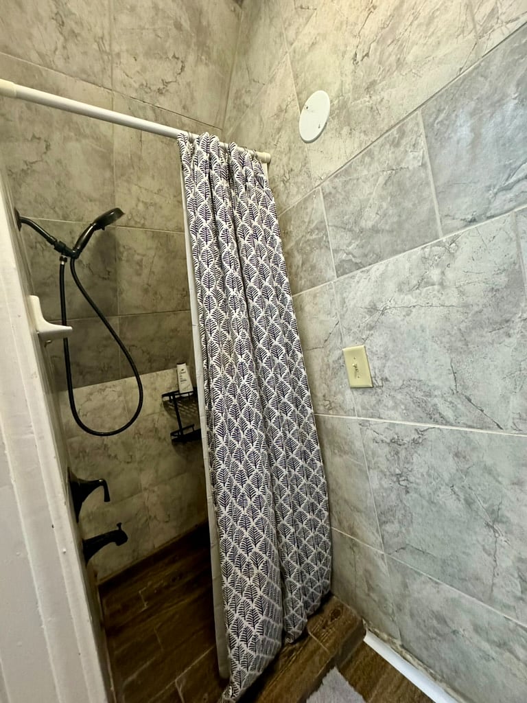 Half bathroom tiled shower