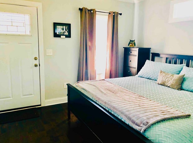 Master bedroom, king sized bed, private entrance into the room from side yard.