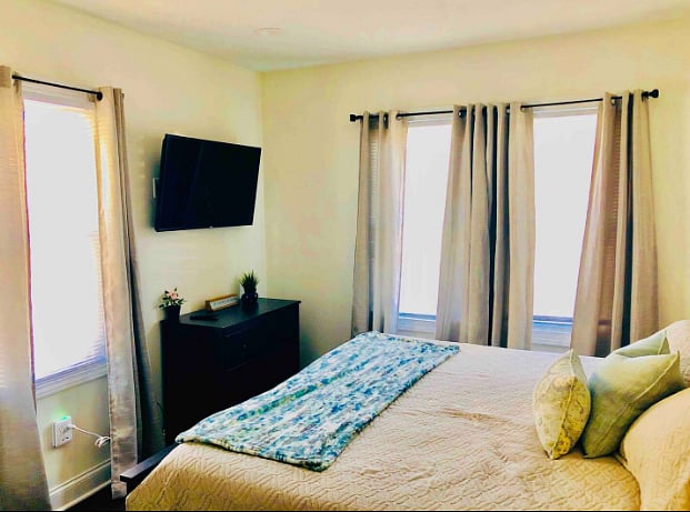 King bedroom (bedroom 3), wall mounted TV, blackout blinds