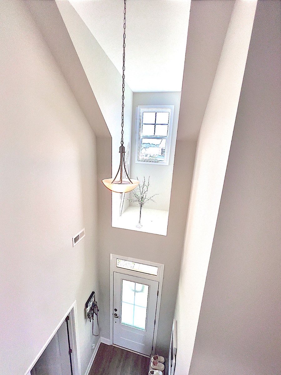 looking down at the front door from upstairs hallway 