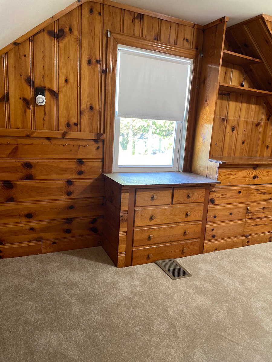 Second floor office space/reading room with black out window treatments. 