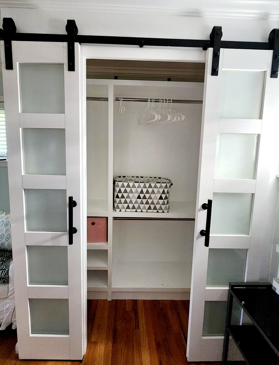 Big remodeled closet with shelves, hanging area and storage space.