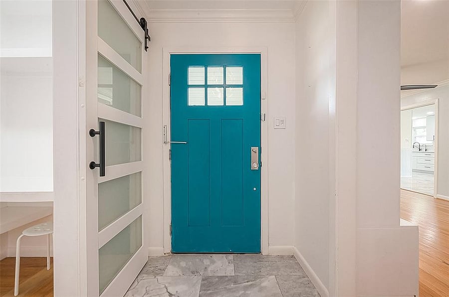 The entry area - your unit is to the right of the front door (left in the photo) and the living area is to the left of the front door (right in the photo)