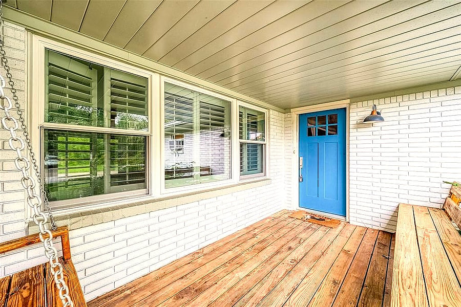 Welcoming front porch with a bench and porch swing, a nice spot to sit and unwind.
